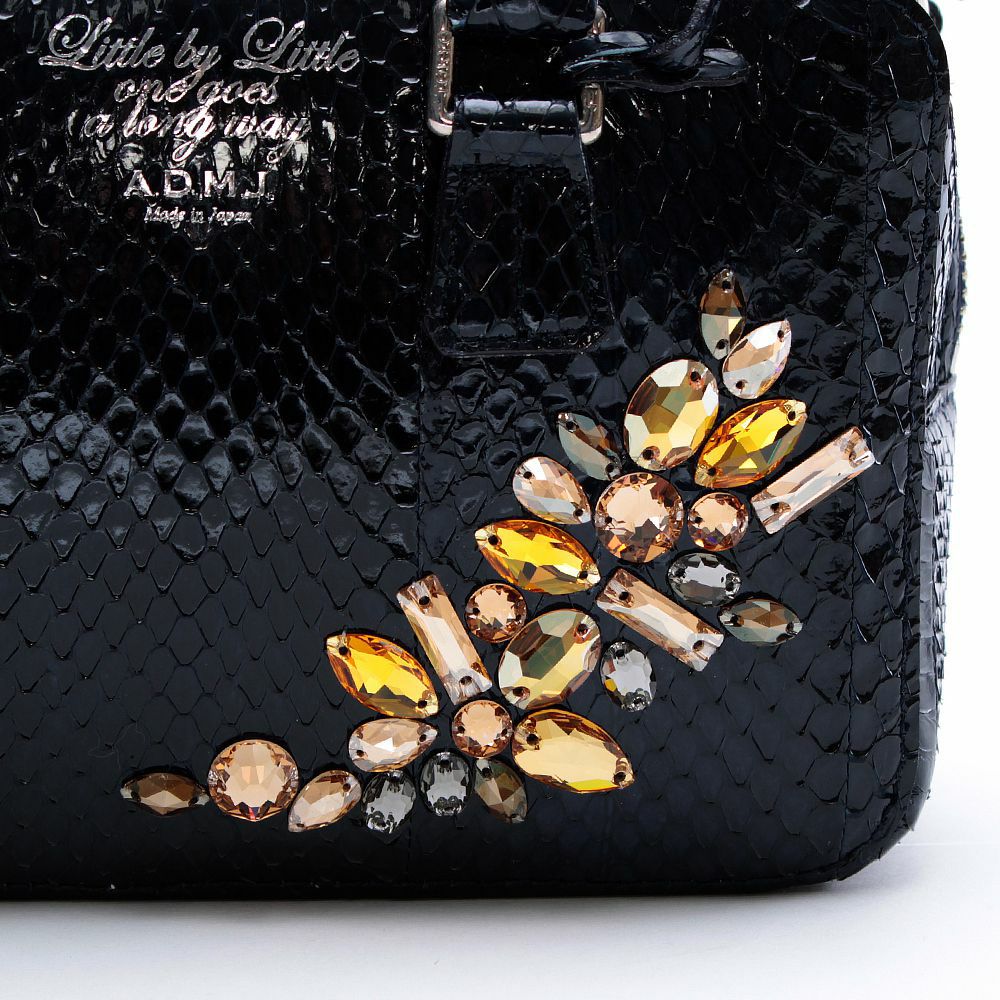 Swarovski Black offers and White Intricate Cutwork Leather Bag.